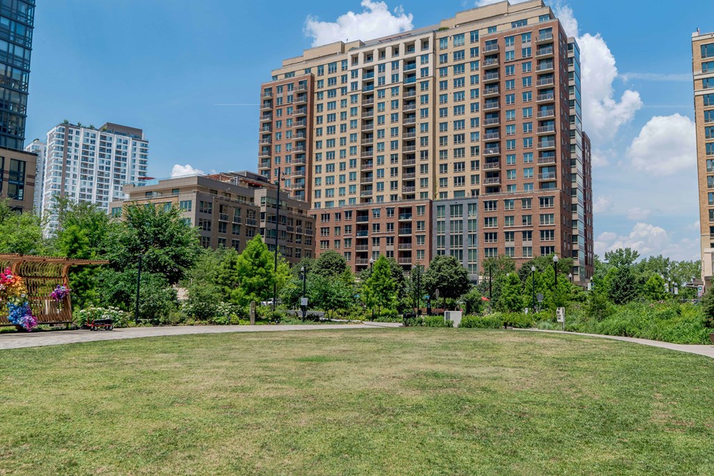 a park in front of some tall buildings